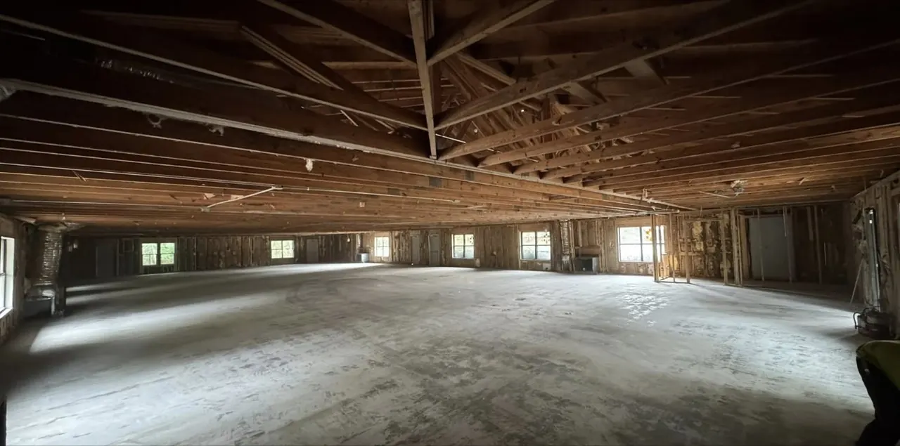 Wood-framed interior gutted down to the slab and roof trusses