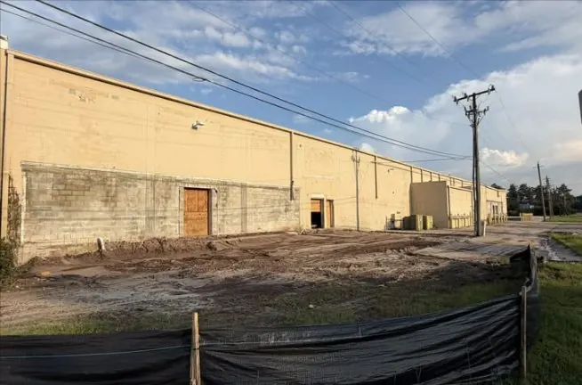 Rear wall of the building with the ground cleared and silt fence up