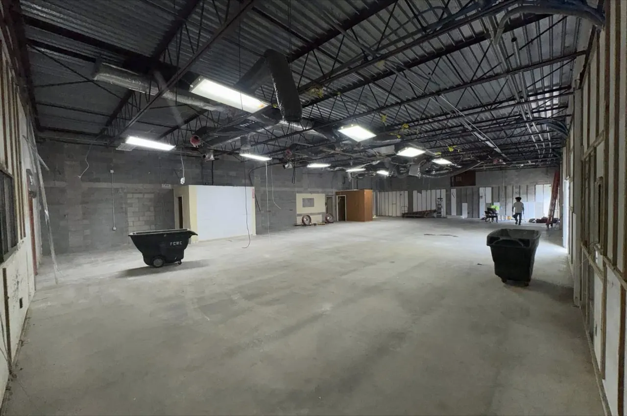 Open warehouse-style interior cleared for a new office