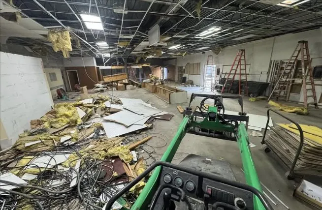 Demo in progress, with debris and a compact loader