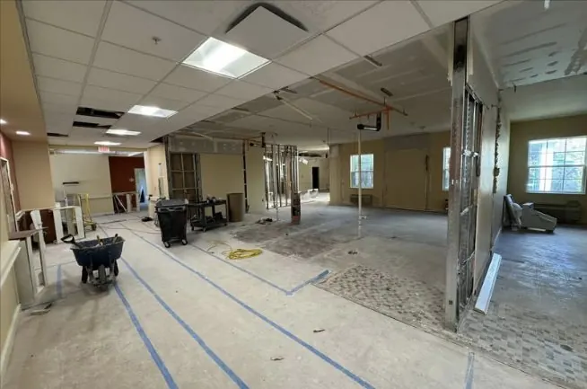 Corridor with partitions removed and layout lines taped on the floor